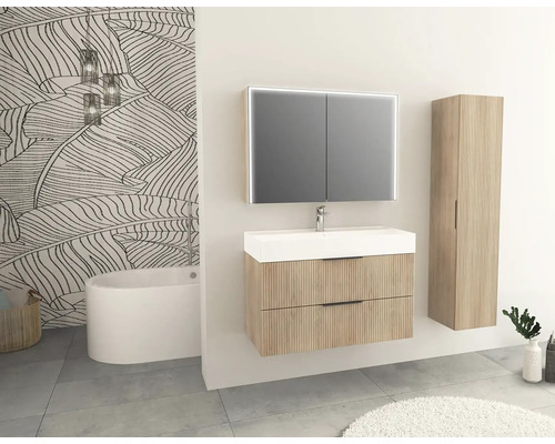 Kúpeľňa s umývadlom, zrkadlovou skrinkou, vysokou skrinkou a vaňou pred stenou so vzorom listov