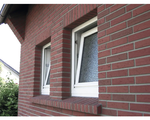 Vonkajší pohľad na dom s dvoma vyklopenými oknami a fasádou z červených tehál