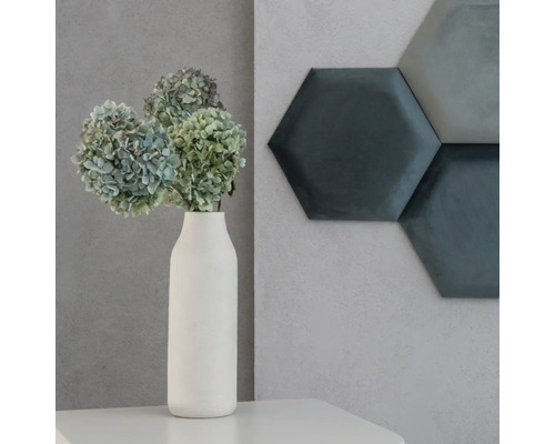 Dekoratívna scéna s kvetmi vo váze a šesťhrannými stenovými panelmi.