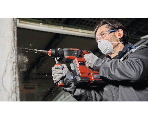 Muž vŕta do steny s vŕtacím kladivom Einhell