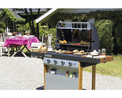 Vonkajšia grilovacia scéna s grilom, jedlom a záhradným stolom