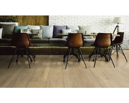 Hosťovská izba s drevenou podlahou, jedálenským stolom a stoličkami