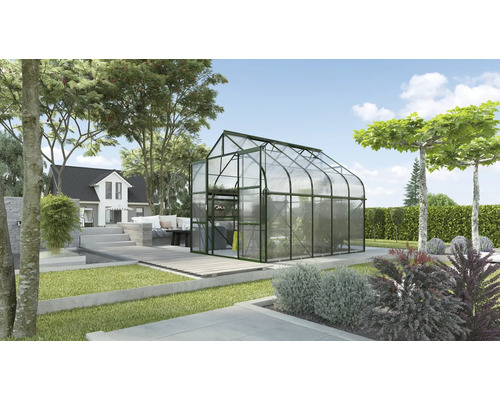 Skleník v záhrade s domom v pozadí