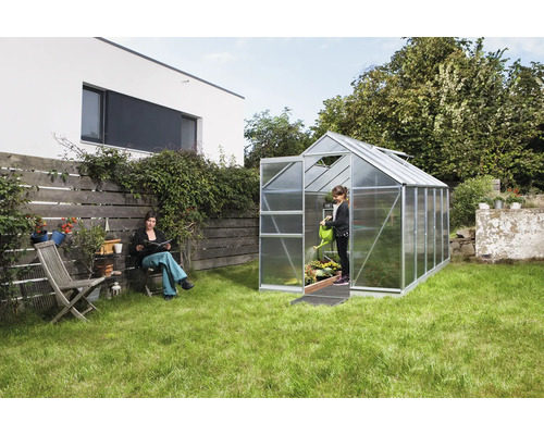 Skleník v záhrade so ženou a dieťaťom