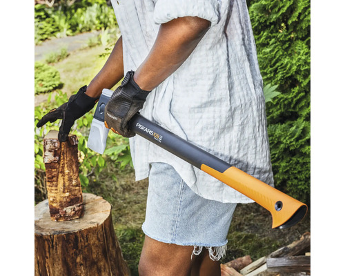 Osoba štiepa drevo pomocou štiepacej sekery Fiskars X28