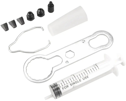 Odvzdušňovacia súprava na bicykel so striekačkou, náradím a adaptérmi.