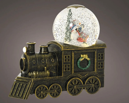 Snehová guľa na vlakovom podstavci so zimnými postavami vo vnútri.