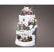 Vianočná miniatúrna dedina s domami, stromami, vlakom a lyžiarskym vlekom na zasneženej hore