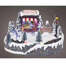 Dekoratívna vianočná scéna s korčuliarmi, predajným stánkom a osvetlením