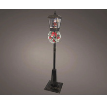 Dekoratívna lampa so snehovou guľou a Santa Clausom, zdobená vencom