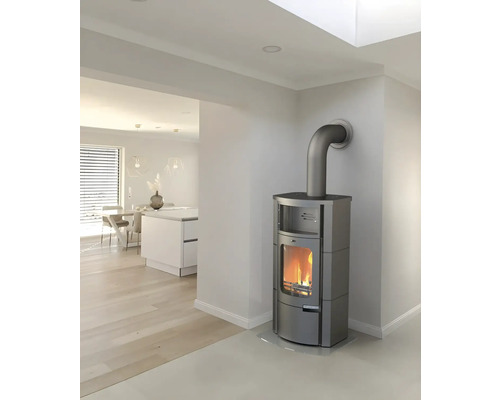 Sivé kachle s rúrou vo svetlej obývacej izbe.