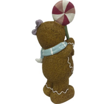 Figúrka medovníkového muža s lízankou ako vianočná dekorácia