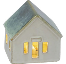 Dekoratívny keramický dom so svietiacimi oknami ako atmosférické osvetlenie