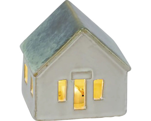 Dekoratívny keramický dom so svietiacimi oknami ako atmosférické osvetlenie