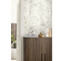 Dekoratívna izba s tapetou so vzorom, drevenou komodou a vázami