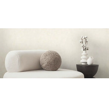 Scéna s kreslom, vankúšom a dekoráciou na odkladacom stolíku