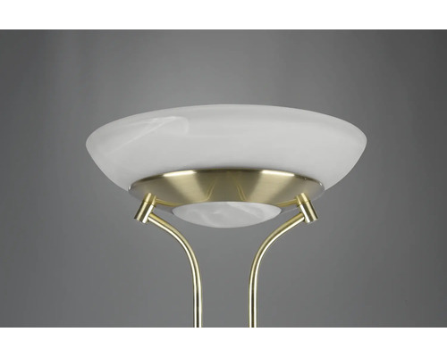 Detailný záber stojacej lampy so skleneným tienidlom a kovovým rámom