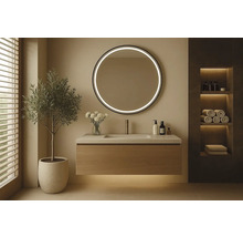 Moderná kúpeľňa s umývadlom, okrúhlym zrkadlom s osvetlením a dekoráciami.