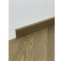 Podlahová lišta s dreveným vzhľadom pri stene