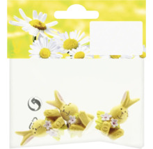 Balenie s tromi žltými figúrkami zajačikov s kvetinovou výzdobou