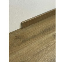 Drevená podlahová lišta na drevenej podlahe pri stene