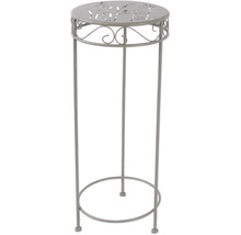 Kovový ozdobný stĺp s rastlinným vzorom na doske stola