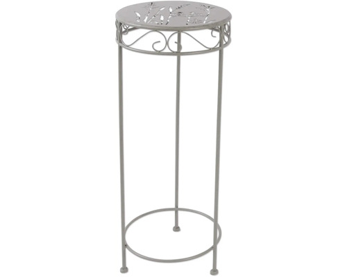 Kovový ozdobný stĺp s rastlinným vzorom na doske stola