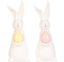 Dve biele veľkonočné figúrky zajačikov s vajíčkom