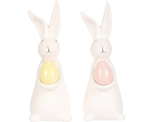 Dve biele veľkonočné figúrky zajačikov s vajíčkom