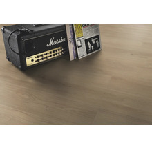 Laminátová podlaha vo vzhľade svetlého duba s autentickou textúrou dreva, doplnená gitarovým zosilňovačom s Marshall Logo a vinylovými platňami.
