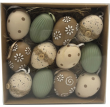 Sada dvanástich veľkonočných vajíčok s rôznymi vzormi ako bodky, kvety a pruhy v krabici so slamou.