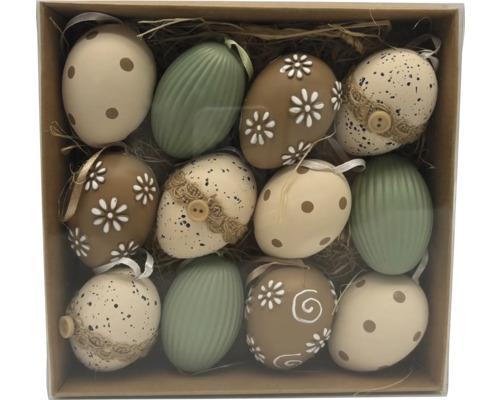 Veľkonočné vajíčka 12 ks Sada dvanástich veľkonočných vajíčok s rôznymi vzormi ako bodky, kvety a pruhy v krabici so slamou.