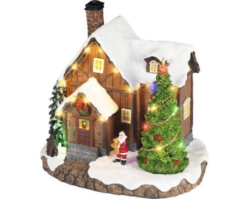 Vianočná dedinka miniatúra so zasneženým domčekom, osvetleným stromčekom, figúrkou Santa Clausa a svetelnou reťazou.
