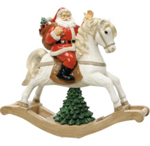 Vianočná figúrka Santa Claus na bielom hojdacom koníkovi nad vianočným stromčekom