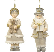 Sada dvoch vianočných ozdôb, dievča s medvedíkom a Santa Claus s darčekom, béžová a zlatá.