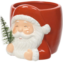 Vianočný keramický kvetináč v tvare Santa Clausa s malým vianočným stromčekom.