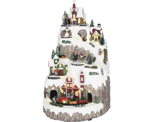 LED osvetlená miniatúrna vianočná dedinka na hore s domami, kostolom, idúcim vlakom a zimnými postavičkami.