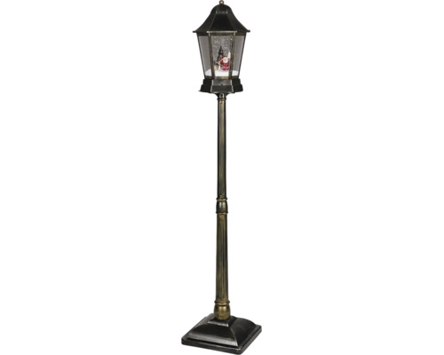 Dekoratívna pouličná lampa v antickom štýle s efektom sneženia, Santa Clausom a vianočným stromčekom.