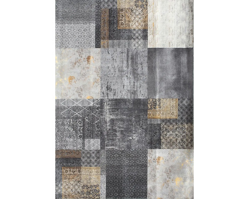 Koberec s patchworkovým vzorom, rôznymi geometrickými a ornamentálnymi motívmi a vintage vzhľadom.