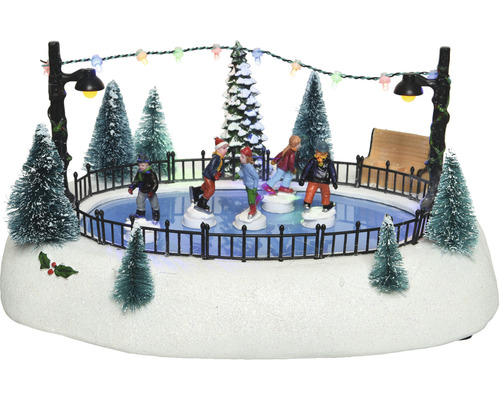 Zimná dedinka so scénou s klziskom, figúrkami a osvetlením ako dekorácia