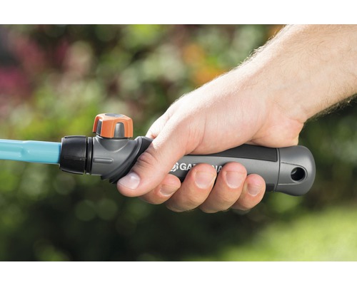 Ruka drží záhradnú hadicu Gardena s uzatváracím ventilom.