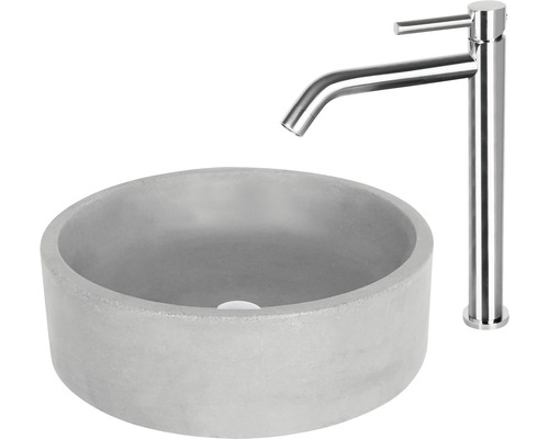 Okrúhle umývadlo na dosku z betónu s vodovodnou batériou