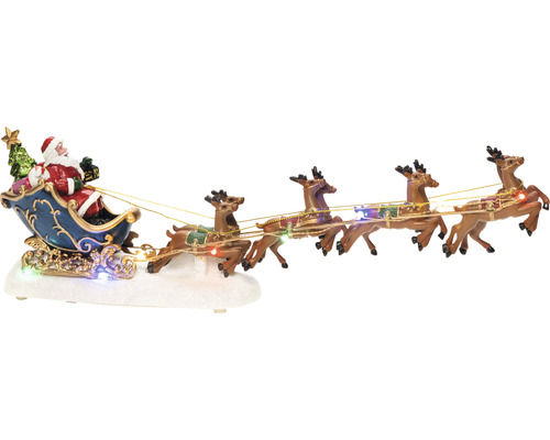 Dekoratívna vianočná scéna so Santa Clausom v saniach ťahaných sobmi