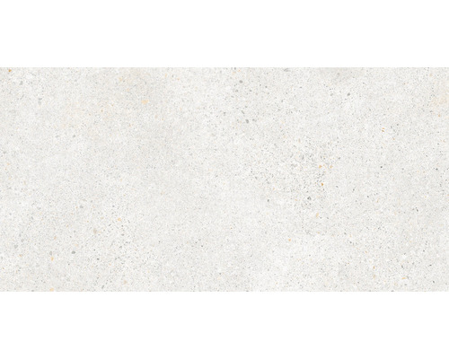 Detail svetlej keramickej dlaždice so vzhľadom terazzo