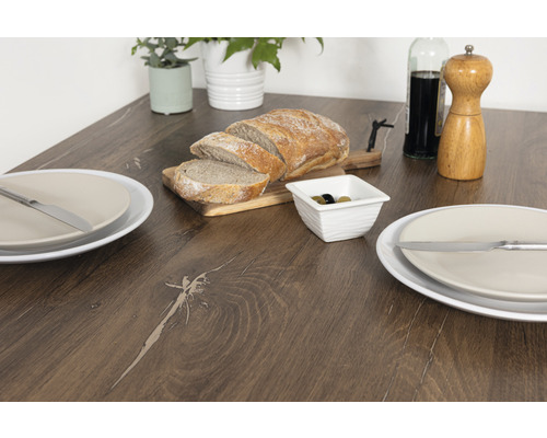 Jedálenský stôl s chlebom, olivami, taniermi a príbormi