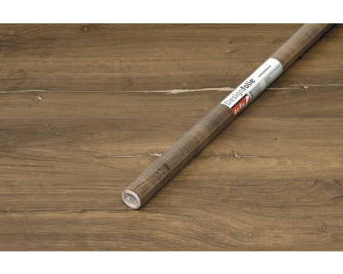 Rolka samolepiacej dekoratívnej fólie s dreveným dekorom na drevenej podlahe