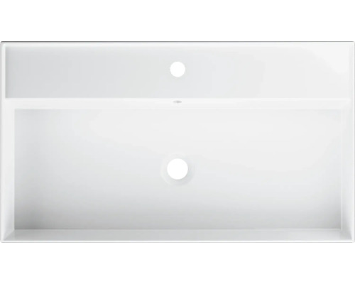 Pohľad zhora na biele umývadlo s otvorom pre batériu a prepadom