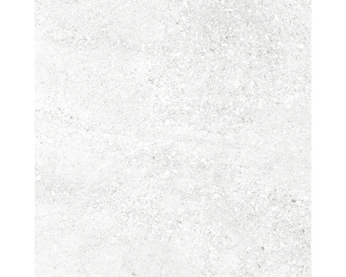 Detailný záber svetlej keramickej dlaždice so škvrnitou textúrou.