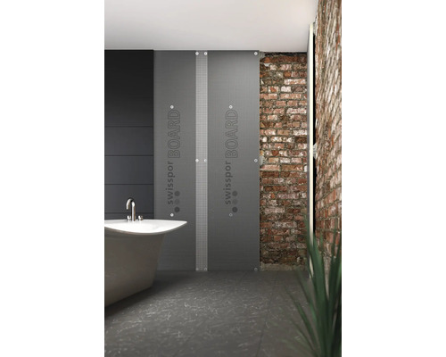 Moderná kúpeľňa s vaňou a dvoma izolačnými doskami Swisspor Board pred tehlovou stenou