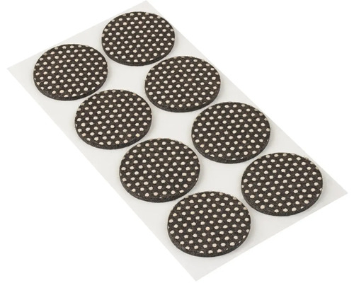 Niekoľko okrúhlych klzákov na nábytok na liste